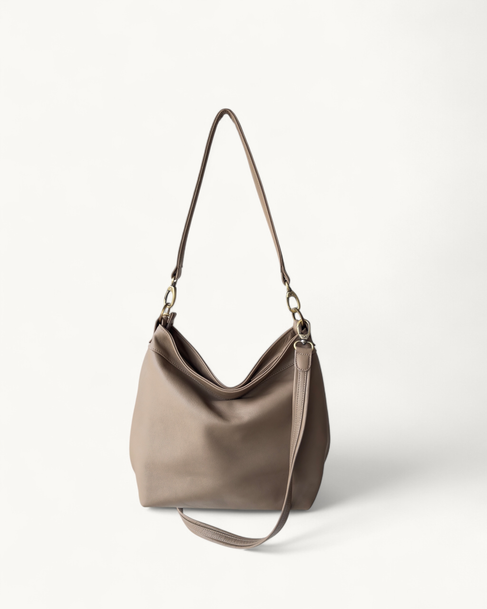 khaki handbag with a shoulder strap on a white background